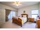 Spacious bedroom featuring a ceiling fan, wood furniture, and a comfortable bed at 4128 Aberdeen Ln, Lake Wales, FL 33859