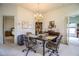 Elegant dining room with glass-top table, chandelier, and views into the kitchen at 4128 Aberdeen Ln, Lake Wales, FL 33859