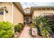 Welcoming front entry with a brick walkway, lush landscaping, and a charming door at 4128 Aberdeen Ln, Lake Wales, FL 33859