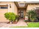 Welcoming front entry with a brick walkway, lush landscaping, and a charming door at 4128 Aberdeen Ln, Lake Wales, FL 33859