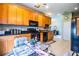 Well-equipped kitchen, offering wood cabinets, black appliances, and a breakfast area at 4128 Aberdeen Ln, Lake Wales, FL 33859