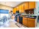 Modern kitchen featuring wood cabinets, black appliances, and a breakfast nook at 4128 Aberdeen Ln, Lake Wales, FL 33859