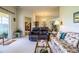 Spacious living room with comfy seating, glass-top coffee table, and access to patio at 4128 Aberdeen Ln, Lake Wales, FL 33859