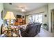 Relaxing living room featuring a leather recliner, floral sofa, and sliding glass doors at 4128 Aberdeen Ln, Lake Wales, FL 33859