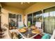 Enjoy dining alfresco on this screened patio with glass table and chairs at 4128 Aberdeen Ln, Lake Wales, FL 33859