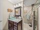 Updated bathroom with granite vanity, glass shower, and modern fixtures at 4128 Mather W Rd, Lakeland, FL 33810