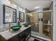 Bathroom boasts dual sinks, granite countertop and a walk in shower at 4128 Mather W Rd, Lakeland, FL 33810