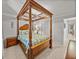 Bedroom with a four-poster bed and access to hallway at 4128 Mather W Rd, Lakeland, FL 33810