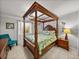 Bedroom with canopy bed and wood nightstands at 4128 Mather W Rd, Lakeland, FL 33810