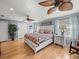 Bright bedroom featuring hardwood floors and a ceiling fan at 4128 Mather W Rd, Lakeland, FL 33810