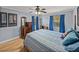 Well-lit bedroom with hardwood floors and a ceiling fan at 4128 Mather W Rd, Lakeland, FL 33810