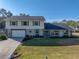 Two-story house with attached garage and landscaped lawn at 4128 Mather W Rd, Lakeland, FL 33810