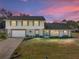 Two-story house with attached garage and landscaped lawn, at sunset at 4128 Mather W Rd, Lakeland, FL 33810