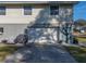 Attached garage with a white door and a driveway at 4128 Mather W Rd, Lakeland, FL 33810