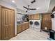 Laundry room with washer, dryer, and cabinets at 4128 Mather W Rd, Lakeland, FL 33810