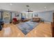 Spacious living room with hardwood floors, leather furniture and large windows at 4128 Mather W Rd, Lakeland, FL 33810