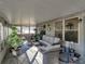 Spacious screened porch with wicker furniture and potted plants at 4128 Mather W Rd, Lakeland, FL 33810