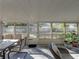 Relaxing screened porch with patio furniture and view of backyard at 4128 Mather W Rd, Lakeland, FL 33810