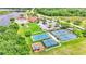 Aerial view of community amenities showcasing playground, basketball and tennis courts, and clubhouse at 4145 Whistlewood Cir, Lakeland, FL 33811