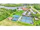 This aerial view showcases a community's sport courts, pool, landscaping, and amenities that enhance an active lifestyle at 4145 Whistlewood Cir, Lakeland, FL 33811