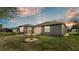 Spacious backyard featuring a covered patio and manicured lawn, perfect for outdoor entertaining and relaxing at 4145 Whistlewood Cir, Lakeland, FL 33811