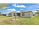 A spacious backyard features well-maintained lawn and leads up to a screened patio at 4145 Whistlewood Cir, Lakeland, FL 33811