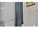 Close up of the shower/tub combination with white tile and a neutral shower curtain at 4145 Whistlewood Cir, Lakeland, FL 33811