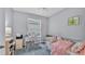 Cozy bedroom with carpet flooring, a white desk, and a comfortable twin bed at 4145 Whistlewood Cir, Lakeland, FL 33811