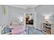 Comfortable bedroom features a plush bed, view to living room, and a convenient bookshelf at 4145 Whistlewood Cir, Lakeland, FL 33811