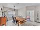 Cozy dining room with a wooden table, bench seating, and pendant lighting, leading to bedroom at 4145 Whistlewood Cir, Lakeland, FL 33811