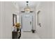 Bright entryway with tile floors, decorative mirror, and recessed alcove at 4145 Whistlewood Cir, Lakeland, FL 33811