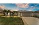 Well-maintained single-story home featuring a landscaped front yard, attached two-car garage, and neutral paint at 4145 Whistlewood Cir, Lakeland, FL 33811