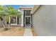 Inviting front entrance featuring a black door, palm tree, and a well-maintained landscape at 4145 Whistlewood Cir, Lakeland, FL 33811