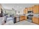 Modern kitchen featuring stainless steel appliances, wooden cabinets, and an open view to the living room at 4145 Whistlewood Cir, Lakeland, FL 33811