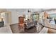 Open-concept living room with dark wood flooring, ceiling fan, and sliding door access to porch at 4145 Whistlewood Cir, Lakeland, FL 33811