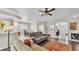 Spacious open-concept with hardwood floors, ceiling fan, view to kitchen, and plenty of natural light at 4145 Whistlewood Cir, Lakeland, FL 33811