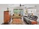 Comfortable living room with dark wood floors, ceiling fan, and views to the screened in porch at 4145 Whistlewood Cir, Lakeland, FL 33811
