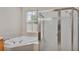 Corner soaking tub and glass enclosed shower in the main bathroom at 4145 Whistlewood Cir, Lakeland, FL 33811