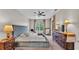 Main bedroom featuring a tufted headboard, ceiling fan, and large windows at 4145 Whistlewood Cir, Lakeland, FL 33811