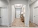 Light-filled hallway with tile flooring and arched doorways at 4215 Prima Lago Dr, Lakeland, FL 33810