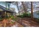 Landscaped backyard with a screened patio and trees at 4419 Burlington Dr, Winter Haven, FL 33880