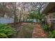 Landscaped backyard with brick pathway and lush greenery at 4419 Burlington Dr, Winter Haven, FL 33880