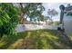 Private backyard with a large grassy area and white fence at 4419 Burlington Dr, Winter Haven, FL 33880