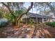 Spacious backyard with screened patio, lush landscaping, and mature trees at 4419 Burlington Dr, Winter Haven, FL 33880