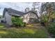 Back exterior view of house, showing a large yard and screened porch at 4419 Burlington Dr, Winter Haven, FL 33880