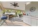Outdoor kitchen and seating area in a screened patio at 4419 Burlington Dr, Winter Haven, FL 33880