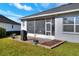 Home features a screened patio, grill, and well-manicured lawn at 4434 Micanope Crescent Dr, Lakeland, FL 33811