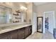Elegant bathroom with double vanity, granite countertop, and large mirror at 4434 Micanope Crescent Dr, Lakeland, FL 33811