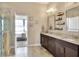 Bathroom features double sinks, granite counters, and a view into the bedroom at 4434 Micanope Crescent Dr, Lakeland, FL 33811