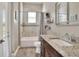 Clean bathroom with granite vanity, bathtub shower combo, and updated flooring at 4434 Micanope Crescent Dr, Lakeland, FL 33811
